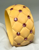 wide quilt carved soft yellow bakelite bangle with pink rhinestones